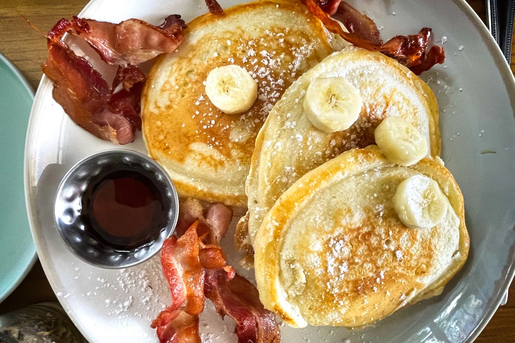 pancakes with maple syrup, streaky bacon and bananas