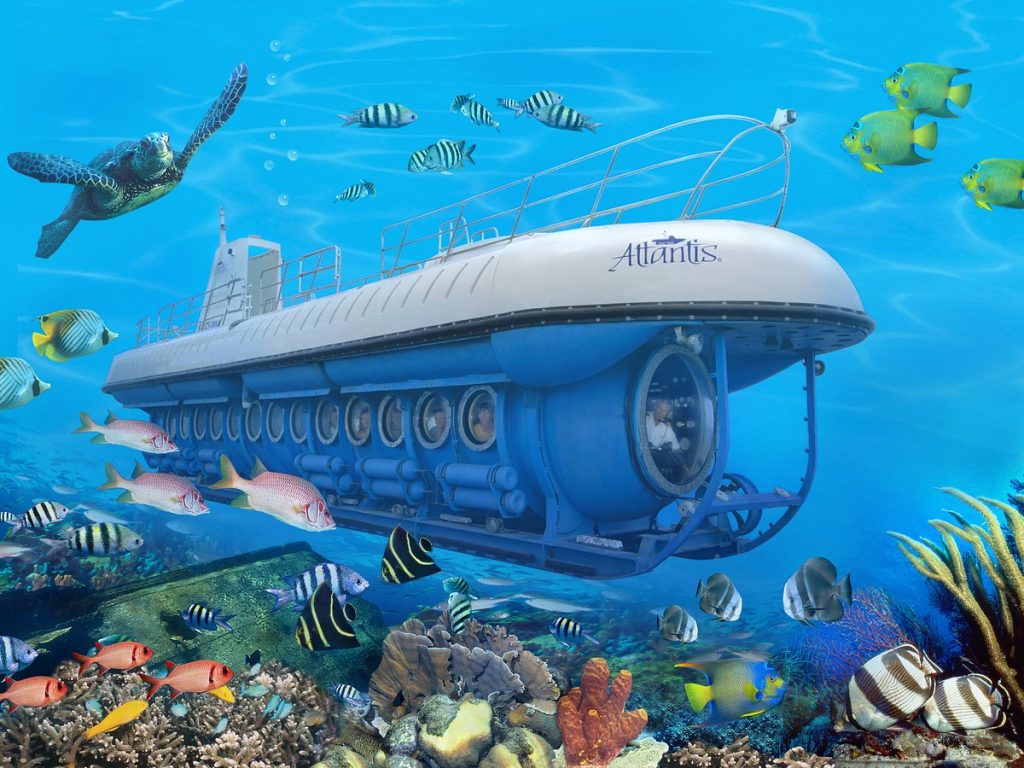 submarine underwater surrounded by fishes, turtles and coral reefs