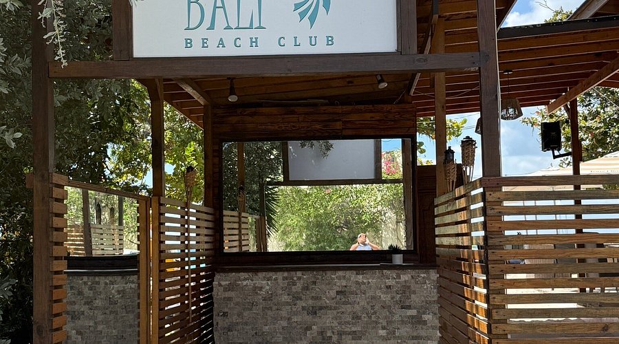 outside of Bali beach club with a sign above a counter