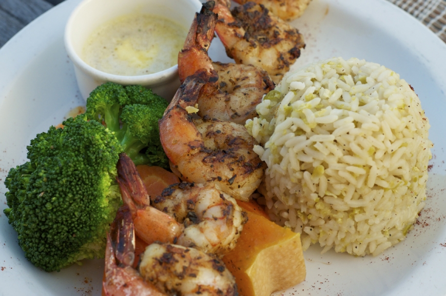 prawns with broccoli and ball of rice on a plate