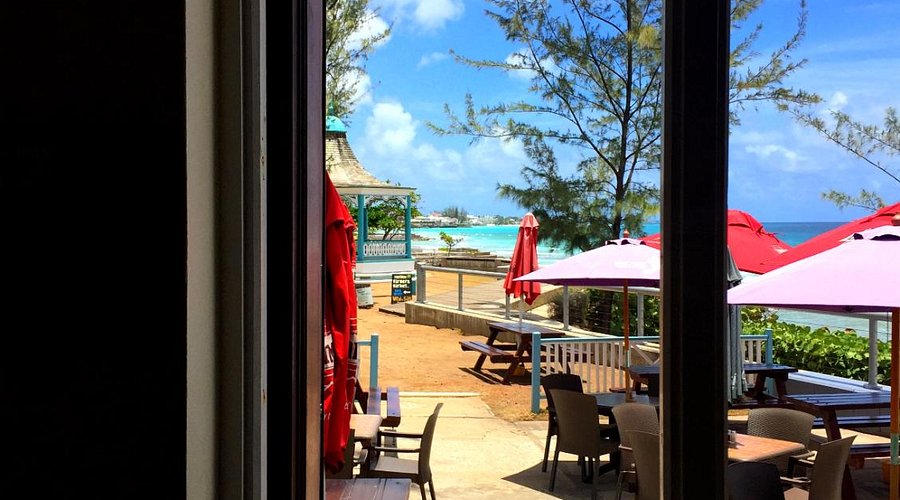 Blakey's outside bar area with red parasol sand a view