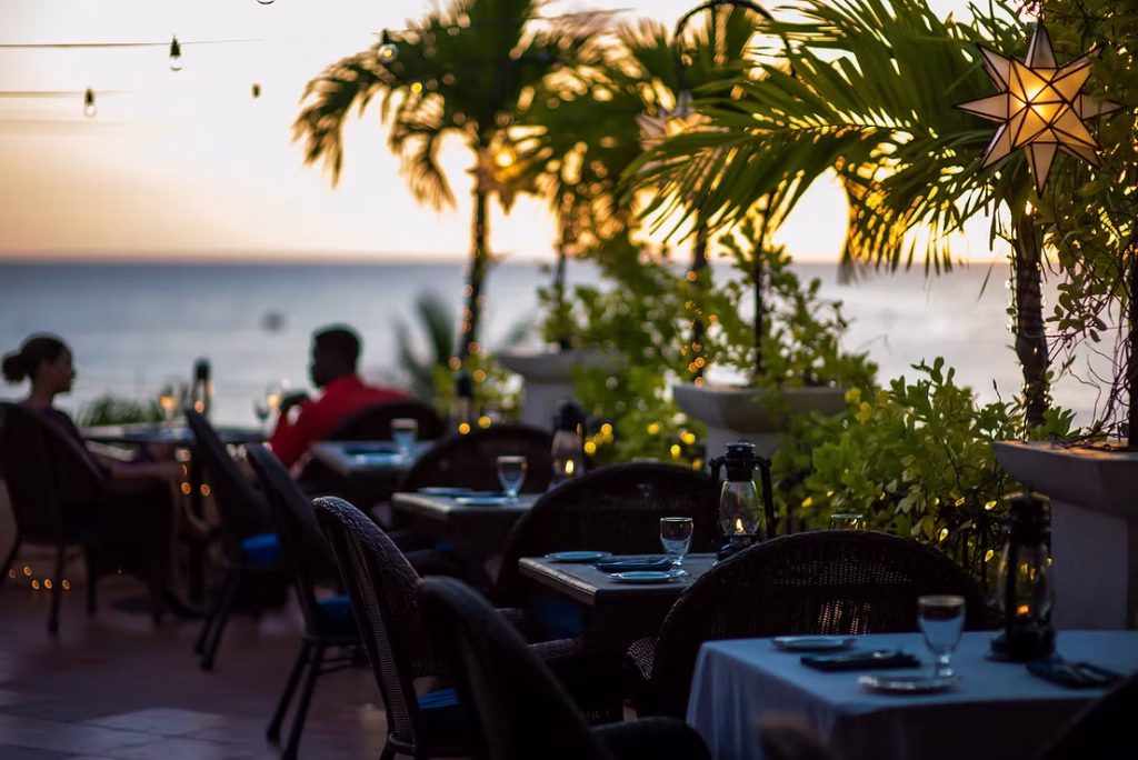sunset restaurant with tables aligned along a floral display