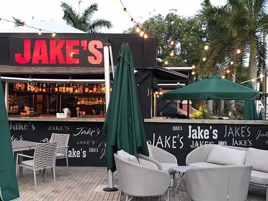 restaurant with jakes above the bar area with seats and parasols around the area