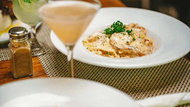 beverage in a glass next to a dish from Jakes