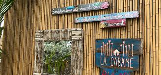 la cabana sign on a wooden wall with other pieces of signs