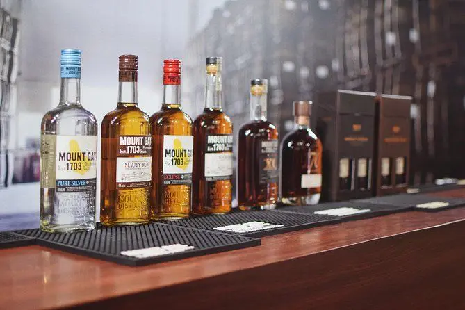 several bottles of mount gay rum lined up together in a bar
