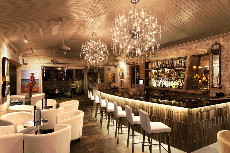 tides inside with golden lights around a modern bar