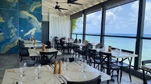 The view restaurant overlooking the ocean with tables next to the window