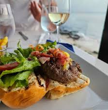 dish from the view on baguette with wine glasses in the background
