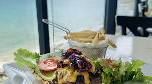 salad with fries next to a window looking over the sea