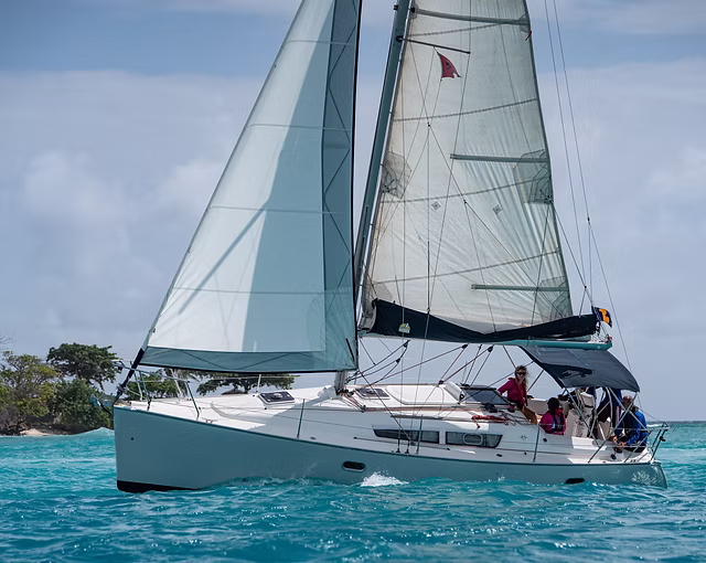 sail boat on sea next to island